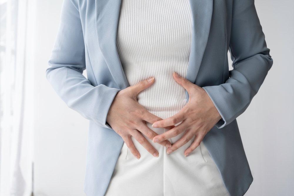 woman clenching her stomach.